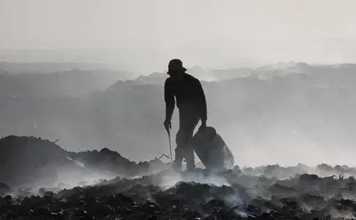 After the 2010 earthquake, NGOs dumped hundreds of thousands of gallons of raw sewage at the end of the Port-au-Prince city landfill, which borders the sea and is not lined with an impermeable material. Image by Marie Arago/NPR. Haiti, 2017.