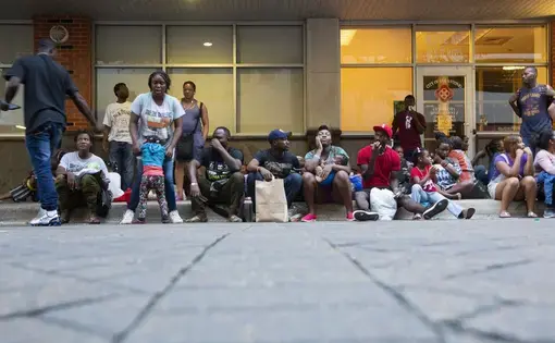 Migrants at a resource center in downtown San Antonio are given food and a bag with basic hygiene products, then escorted to a nearby shelter to spend the night. Image by Marjorie Kamys Cotera. United States, 2019.