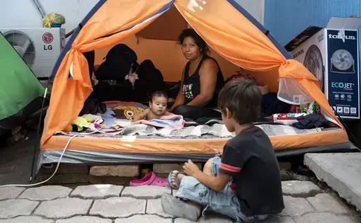 Vanessa Ramos Chavez rested in a tent at Senda de Vida migrant shelter in Reynosa, Mexico, on Saturday. She said she arrived at the shelter from El Salvador more than a month ago with her infant son, Anderson Josue. Image by Miguel Gutierrez Jr. Mexico, 2019.