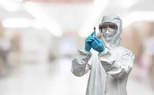 A lab technician scientist in PPE. Image by Chinnapong / Shutterstock.
