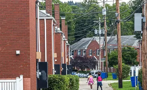 Children walking through the neighborhood.