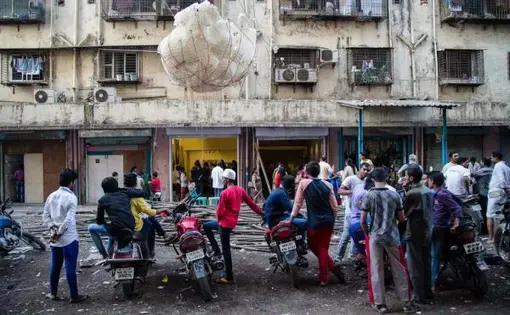 Dharavi residents gather around a sculptural installation outside the Shama Building. Image by Matthew Niederhauser. India, 2015. Media file: c3f0df39a.jpg