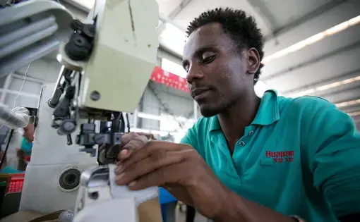 In the Chinese-owned Huajian Shoe Co. Factory in Addis Ababa, more than 6,000 workers build shoes for American brands such Tommy, Guess and Lucky. Image by Noah Fowler. Ethiopia, 2017.