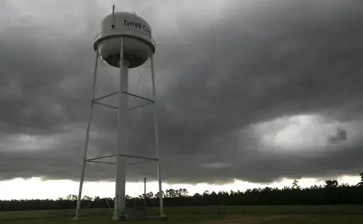 A thunderstorm moves over the Tyrrell County water tower at the water treatment plant on Thursday, July 23, 2020. Image by Robert Willett / The News &amp; Observer / North Carolina News Collaborative. United States, 2020.