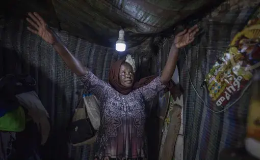 Mother of two Amsale Hailemariam, a domestic worker who lost work because of the coronavirus, stands in her small tent in the capital Addis Ababa, Ethiopia on Friday, June 26, 2020. Decades of progress in one of modern history's greatest achievements, the fight against extreme poverty, are now in danger of slipping away due to the coronavirus and the world could see the first global increase in extreme poverty in 22 years, further sharpening inequality. Image by AP Photo/Mulugeta Ayene. Ethiopia, 2020.