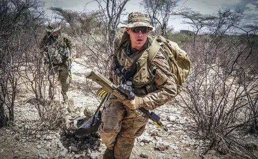 Paratroopers assigned to the 1st Battalion, 508th Parachute Infantry Regiment, 3rd Brigade Combat Team, 82nd Airborne Division provide emergency medical care to a simulated casualty during a live-fire exercise alongside British paratroopers from 2 PARA. Image courtesy of the U.S. military's press photos. Kenya, 2018.