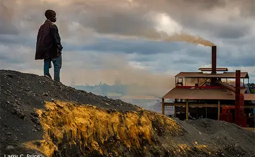 Children work among adults in this area at the base of an operating manganese reprocessing smelter managed by the Chinese company Super Deal. The smelter burns lead and manganese slag and spews toxic fumes across the Kabwe area. Image by Larry C. Price. Zambia, 2017.