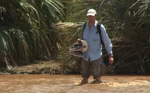 Photographer Guillaume Bonn has to cross a river to get access to the story. Image by Guillaume Bonn. Kenya, 2014. Media file: meetthejournalists.still001.jpg