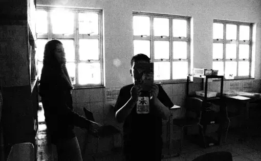 A child with ASD (autism spectrum disorder) hides from the camera after completing his lessons at the Association of Friends of Autistics. With Brazil's winter break in session, he is one of the few children seen in the education facility. Image by Amanda Michelle Gordon. Brazil, 2018.&nbsp;