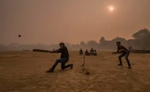 Surrounded by a thick layer of pollution that settled over Patna overnight, a dawn cricket match gets underway at Gandhi Maidan Park in central Patna. Image by Larry C. Price. India, 2018.