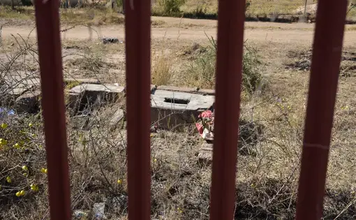 A ground pit latrine that has been gated off due to the immediate danger it posed to students at the Utjane Primary School in Limpopo. Image by Adam Yates. South Africa, 2018. A ground pit latrine that has been gated off due to the immediate danger it posed to students at the Utjane Primary School in Limpopo. Image by Adam Yates. South Africa, 2018.
