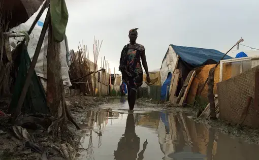A woman walks through the flooded IDP camp in Malakal, South Sudan. Image by Ty McCormick. South Sudan, 2014. Media file: malakal.jpg