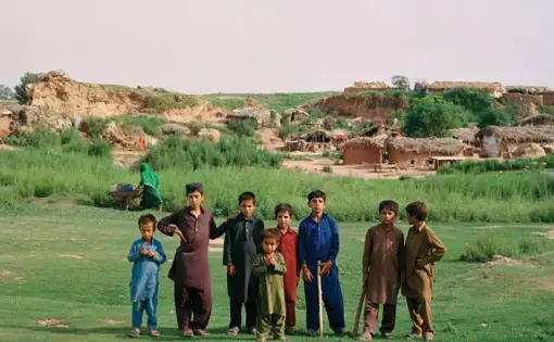 Young Afghan boys pose for a portrait on the outskirts of Islamabad. Sixty percent of Afghans in Pakistan are younger than 24. Image by Sara Hylton. Pakistan, 2019.