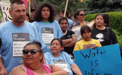 Grassy Narrows community members stand together at their River Run event in Toronto. Image by Shelby Gilson. Canada, 2019.