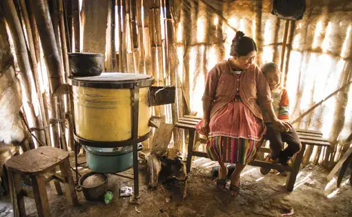 In Jocotenango, Guatemala, Rosa de Sapeta's family used to avoid her smoke-filled kitchen. But since an aid group helped her replace the open fire with a cleaner burning stove, she says, "I have company while I cook." Image by Lynn Johnson. Guatemala, 2017.