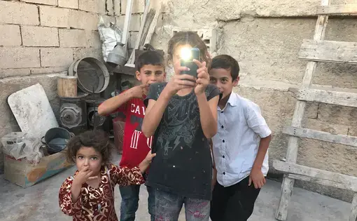Little ones in a house being restored in Manbij, Syria, one year after the town's liberation from ISIS. Image by Gayle Tzemach Lemmon. Syria, 2017. 