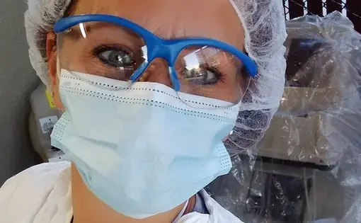 Tiffany Cordaway, 47, as seen in this April 23 selfie, was working two jobs and living in a friend’s car at the start of the pandemic. For her day job, she wears protective gear while disinfecting medical equipment, including some used on COVID-19 patients. At night, she cares for the elderly. Image courtesy of Tiffany Cordaway. United States, 2020.