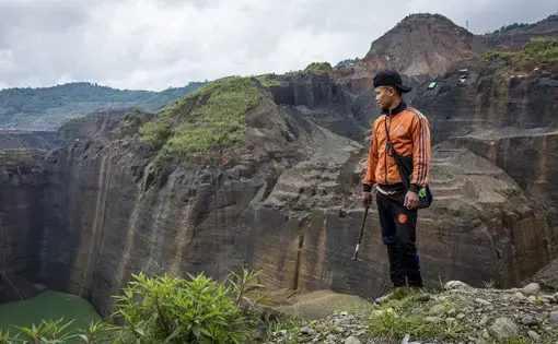 Gum Jat, 31, looks over a jade mining site in Hpakant, Kachin State, where he has worked as a freelance miner for eight years. Image by Hkun Lat/Frontier. Myanmar, 2020.