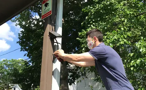 Doug Quattrochi, pictured installing solar panels, runs MassLandlords.net, the largest nonprofit for owners and managers of Massachusetts residential real estate. Image courtesy of Doug Quattrochi. United States, 2020.