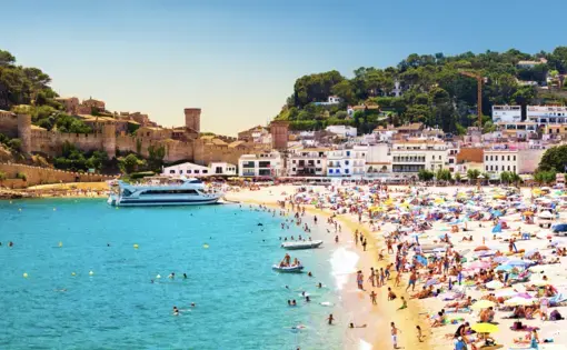 Coast with tanning and bathing people (Panorama of Costa Brava, Tossa de Mar city, Spain). Image by Denis Mironov/Shutterstock. Spain, undated.