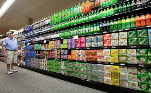 Steve Close of Fox Point shops in an aisle of sodas, energy drinks, drink mixers and more at Sendik's Food Market in Mequon. Image courtesy of Colin Boyle. United States, 2019.