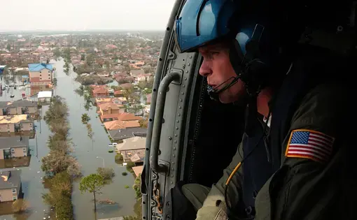 Coast Guard Petty Officer 2nd Class Shawn Beaty, 29, of Long Island, N.Y., looks for survivors in the wake of Hurricane Katrina, New Orleans, 2005