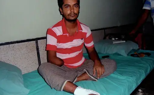 Rana Plaza survivor Saddam Hossain recovers in a hospital after the building collapse claimed part of his right arm. Image by Golam Mortuja. Bangladesh, 2016.