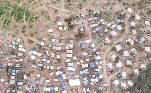 Aerial view of Moria Refugee camp and makeshift settlement around it. Image by Nicolas Economou / Shutterstock. Greece, 2020.
