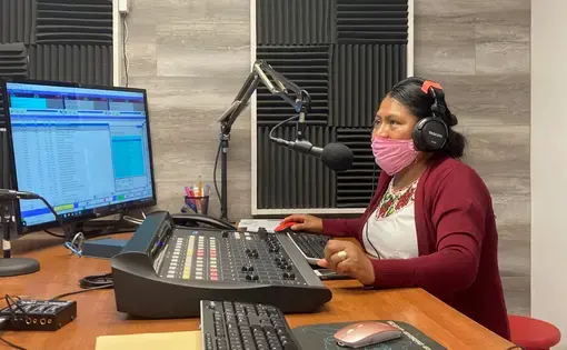 Lidia López prepares to go on-air from Radio Indígena's programming booth in Oxnard in July. Image by Julia Knoerr. United States, 2020.