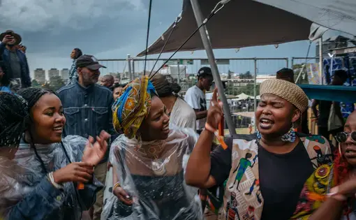 While the Afropunk Joburg festival was on pause because of the weather, crowds make their own music, singing freedom songs. Image by Melissa Bunni Elian. South Africa, 2017.