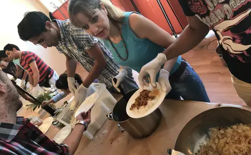 Members of a church in southern Berlin serve Iranian stew after Sunday service to a congregation of moslty Iranian and Afghan converts. Image by Alice Su. Germany, 2017.