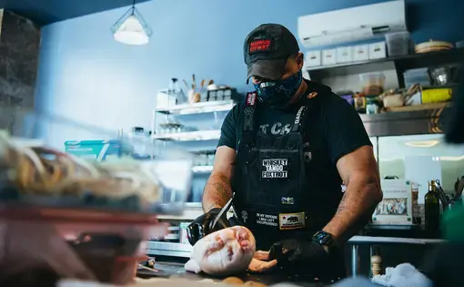 A chef prepares food for takeout at Reverence, a fine dining restaurant in Harlem.