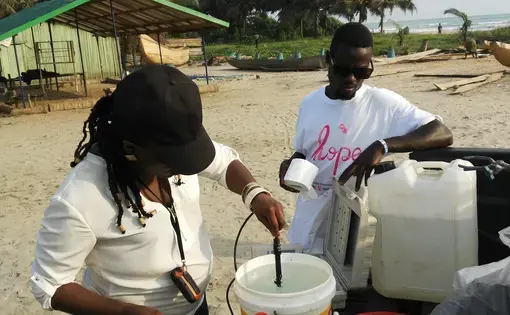 Adwoba Edjah of the Ghana Atomic Energy Commission samples water to measure contaminants from illegal mining. She will test samples at a research reactor in Accra, Ghana's capital. Image courtesy of Adwoba Edjah. Ghana, 2017. 