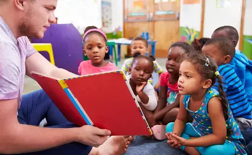 Nursery school children in South Africa are taught by a volunteer teacher. Image by Rex/Shutterstock.
