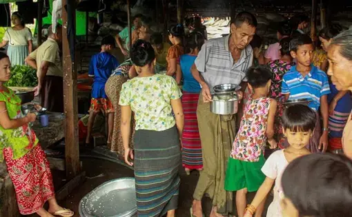 Internally displaced persons (IDPs) cook at a camp in Rakhine State last week. With social distancing nearly impossible, IDPs are at risk of contracting the coronavirus. Myanmar, 2020.