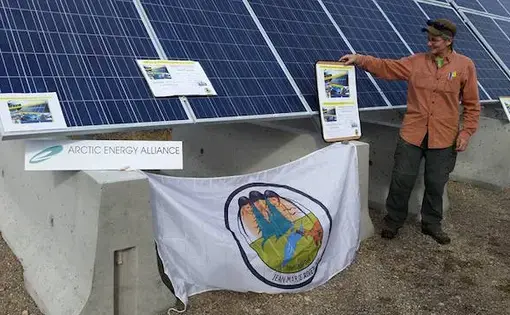 Teresa Chilkowich, of Arctic Energy Alliance, in front of the new solar panel in Jean Marie River. Image by Jean Marie River First Nation. Canada, 2016.