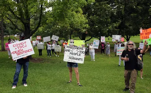 Family members of prisoners held in Texas' state prison system demonstrate at the Governor's Mansion in Austin for their release on parole due to the danger of COVID-19 in prisons. Image by Vic Hinterlang / Shutterstock. United States, 2020.