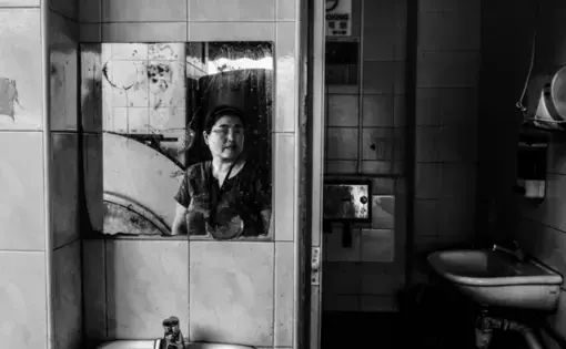 Ms. Feng, 41-year-old, works at a noodle factory. Her hand was injured during work. The intermediary company, which introduced her to the job in Singapore, refused to refund her. Before got injured, she only worked in Singapore for 25 days. Image by Xyza Bacani. Singapore, 2017.