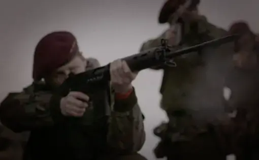 A soldier shoots a gun during a scene in The Ballymurphy Precedent trailer. Image courtesy of Dartmouth Films. Ireland, 2018.