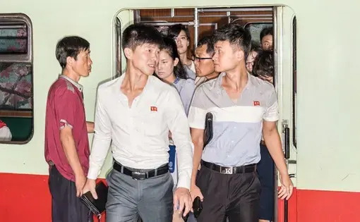 Commuters on the Pyongyang Metro. The capital, marooned by politics, presents a panorama from another time. Image by Max Pinckers/The New Yorker. North Korea, 2017.
