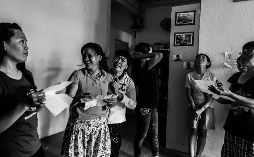 Runaway migrant workers practiced a song inside the shelter to stay active despite their painful situations. Image by Xyza Bacani. Singapore, 2016.