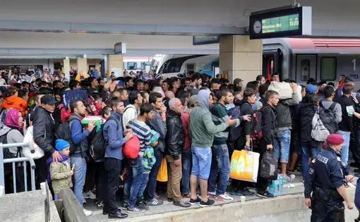 Migrants at Wien Westbahnhof railway station on their way to Germany. Image by Bwag courtesy Wikimedia Commons.  Austria, 2015.
