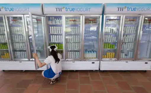 A worker takes care of inventory at a TH Truemart factory store in Nghia Son, Vietnam. Image by Mark Hoffman. Vietnam, 2019.