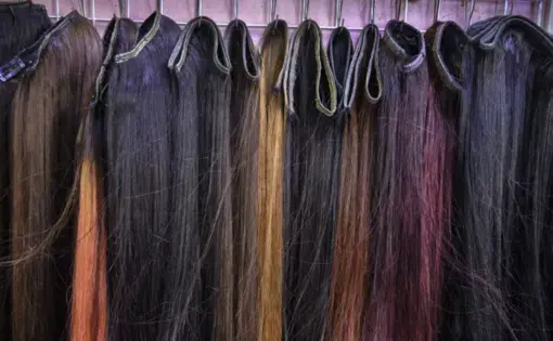 Hair pieces on display at a salon in Phnom Penh. Image by Paula Bronstein. Cambodia, 2019.