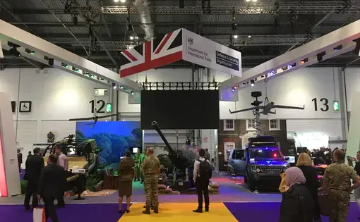 The British quarter at the world's largest arms fair, DSEI in London. The Defence &amp; Security Organisation, a taxpayer funded organ of the UK government, has its logo raised high - it ploughs significant sums into promoting British arms companies exports around the world, including organising arms fairs. Image by Matt Kennard. United Kingdom, 2017. 