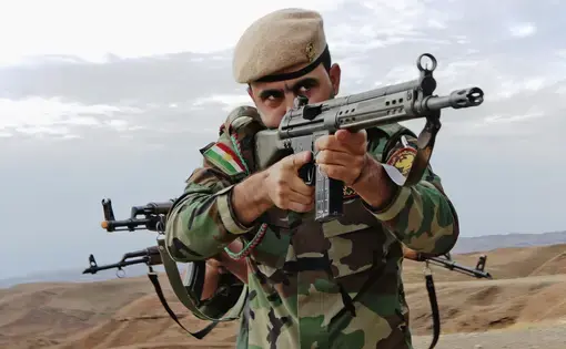 A Kurdish peshmerga soldier takes the lead during urban combat maneuvering training held near Erbil. Image by Spc. Tristan Bolden / U.S. Army. Iraq, 2015.