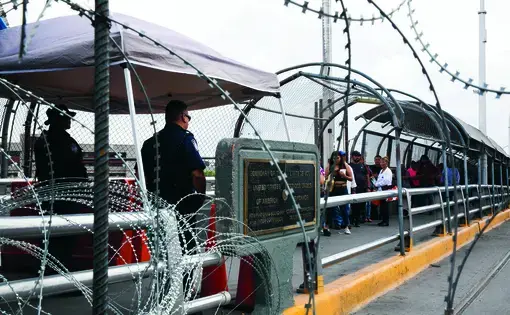 Razor wire is strung along the U.S. and Mexico sides of a port of entry in El Paso, Texas. Image by Jinitzail Hernández. United States, 2019.