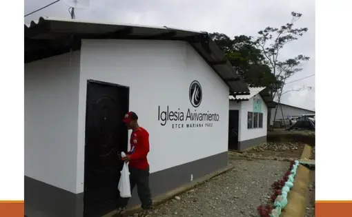 Eder Caicedo Cristian unlocks the community church in the FARC transition zone Mariana Paez. The church is one of five built by Avivamiento, a Bogotá-based evangelical church. Image by Julia Friedmann. Colombia, 2018.