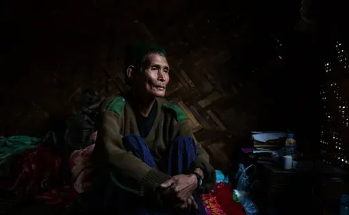 Dawng Hkawng, who was displaced by the Chipwi dam project in 2012, sits in his small room in the Chipwi internally displaced persons camp in Chipwi, Kachin State, Myanmar. Image by Hkun Lat. Myanmar, 2019.