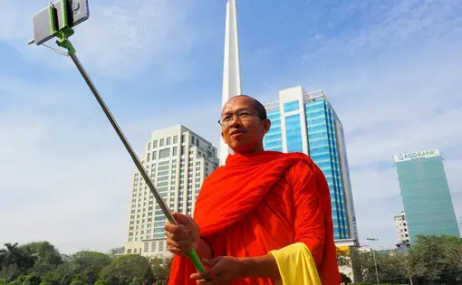 A monk takes a selfie in Yangon. Image by Doug Bock Clark. Myanmar, 2017.